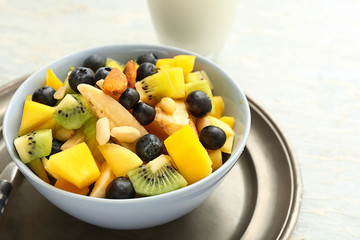 Bowl with tasty mango salad on table