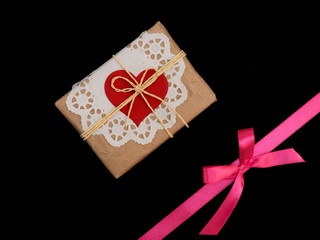 Bow from pink satin ribbon horizontally and present on black background