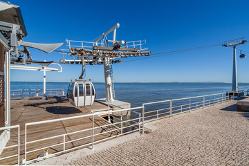 Lisbon, Portugal. Aerial Tramway leaving or entering terminal aka embarking or docking station, Parque das Nacoes aka Nations Park with Tagus River.