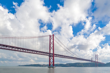 Lisbon, Portugal. Ponte 25 de Abril Suspension Bridge over the Tagus or Tejo river with Cristo Rei Sanctuary. Connects the cities of Lisbon and Almada.