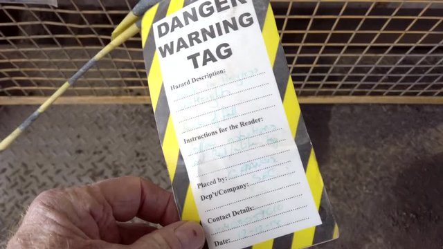 Reading a danger tag being to control entry to work areas