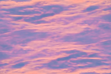 Beautiful abstract background of blue and pink stains, multicolored divorces Storm clouds illuminated by the sun at sunset.