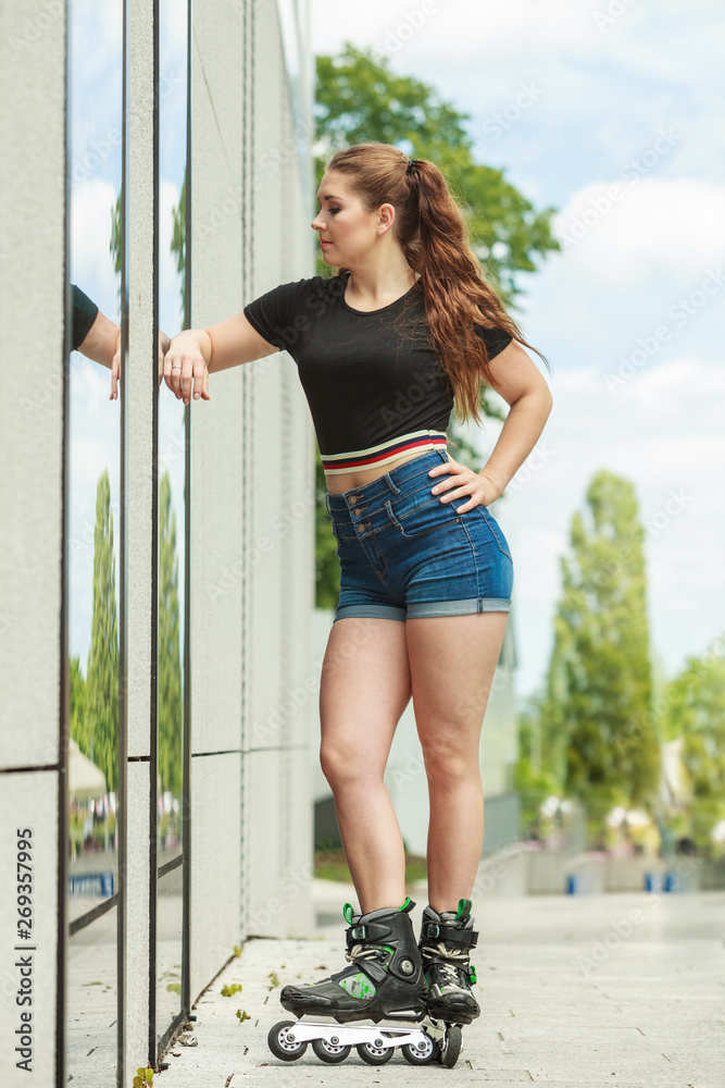 Poster Young woman riding roller skates