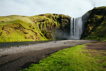 Amazing view of popular tourist attraction. Location famous Skogafoss waterfall, Skoga river, Iceland, Europe.