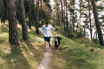  Man playing with a dog in the woods