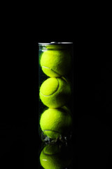 Tennis Ball isolated on black with dramatic lighting