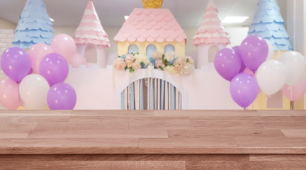Empty wooden table with blurred wedding or birthday party background