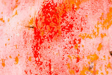 Fototapeta premium Old corroded metal wall background with flaky red paint .Rusty flaky cracked metal surface.Abstract the surface texture of the old metal.