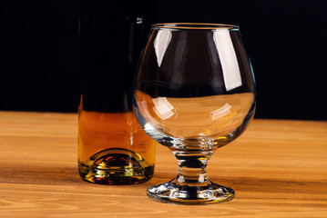 Glass of cognac and a bottle