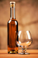 Glass of cognac and a bottle