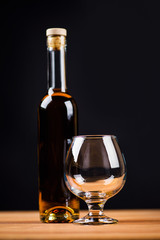 Glass of cognac and a bottle