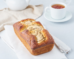 Whole banana bread, cake with banana. The morning Breakfast on light grey background