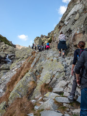  Hikers on trail at Great Cold Valley,  Vysoke Tatry (High Tatras), Slovakia. The Great Cold Valley is 7 km long valley, very attractive for tourists