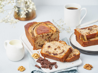 Banana bread. Sliced cake with banana, chocolate, walnut. Traditional american cuisine, breakfast with coffee. Side view