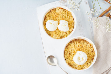 Apple crumble with ice cream, streusel. Morning breakfast on a light gray table. Top view, copy space