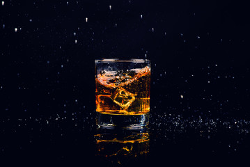 Isolated shot of whiskey with splash on black background
