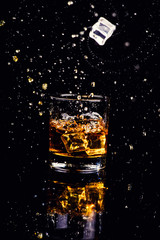 Isolated shot of whiskey with splash on black background