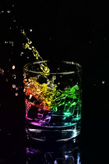 Isolated shot of whiskey with splash on black background