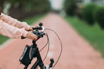 woman cyclist riding a bike on bike path, close-up