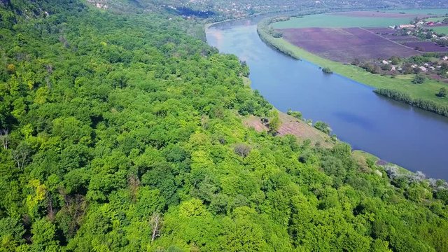 Flight over the river and forest at spring time. Dniester river of Moldova republic.