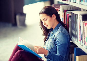 education, high school, university, learning and people concept - student girl reading book sitting...