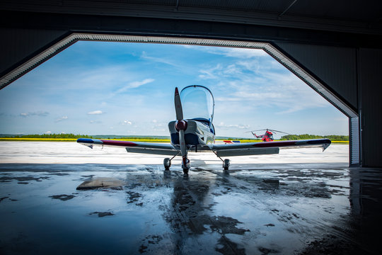 propeller plane in a hangar at an airfield