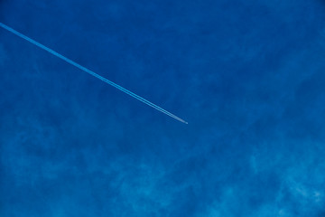 Concept photo of a blue sky background with feather clouds on a sunny day with a dry sun.