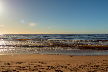 Fototapeta na wymiar Calm Baltic sea background in golden hour