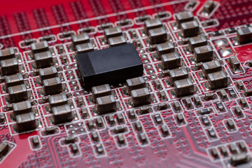 Transistors from the back of the video card under the graphic core. Macro shooting of a red...