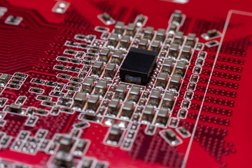 Transistors from the back of the video card under the graphic core. Macro shooting of a red...