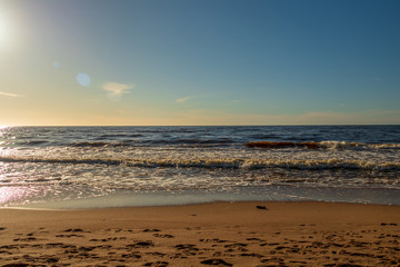 Fototapeta na wymiar Calm Baltic sea seashore beach background in golden hour