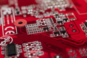 Transistors from the back of the video card under the graphic core. Macro shooting of a red...