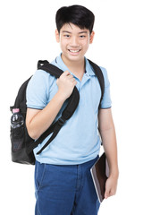 Fototapeta premium Smiling little student boy in blue polo t-shirt in with books and bag.