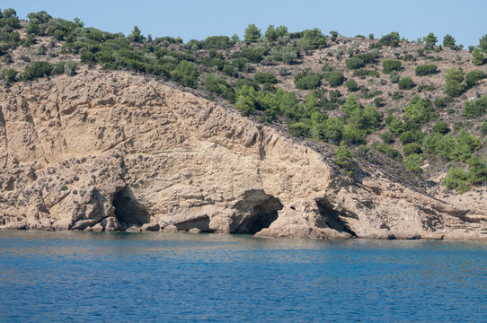 group of caves carved by the sea seen from the yacht