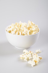 Popcorn in bowl isolated on white background.