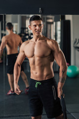 Fototapeta na wymiar Young muscular man in the gym doing exercise