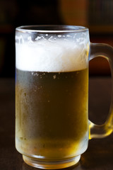 Cold beer on a wooden table in a restaurant
