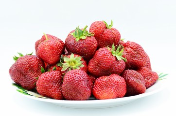 Ripe juicy strawberries lies on a plate