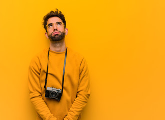 Young photographer man tired and bored