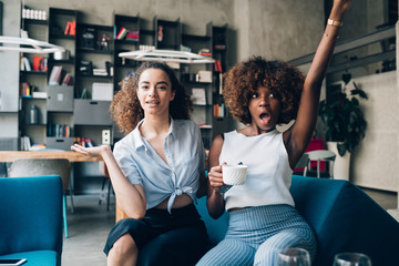 two young multiracial women having fun and looking camera