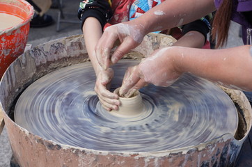 hands of potter on potters wheel