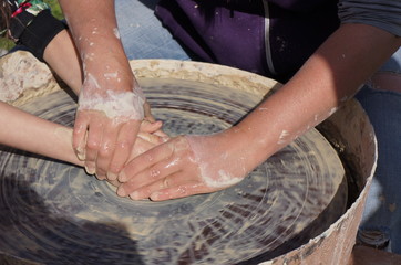 hands of potter on potters wheel