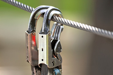 locked safety hook on rope closeup view of hiking equipment isolated on blur background security...