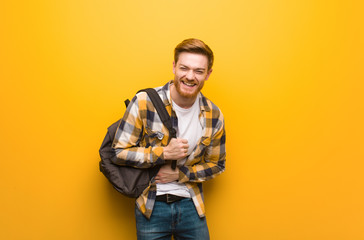 Young redhead student man laughing and having fun