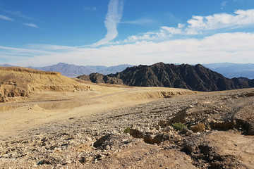 Israel. The neighborhood of Eilat. Mountain roads of the Negev desert. Black rocky ridge