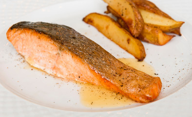 Prepared salmon on the white plate
