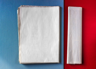 blank news papers on red and blue background