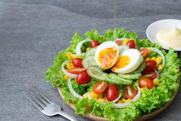 Healthy vegetables salad with boiled egg in wooden dish on table for vegetarian.