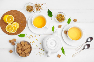 teapot and cups of tea on a white wooden background