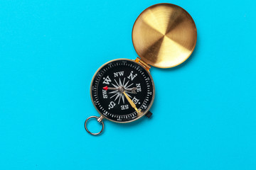 Compass on blue background, top view